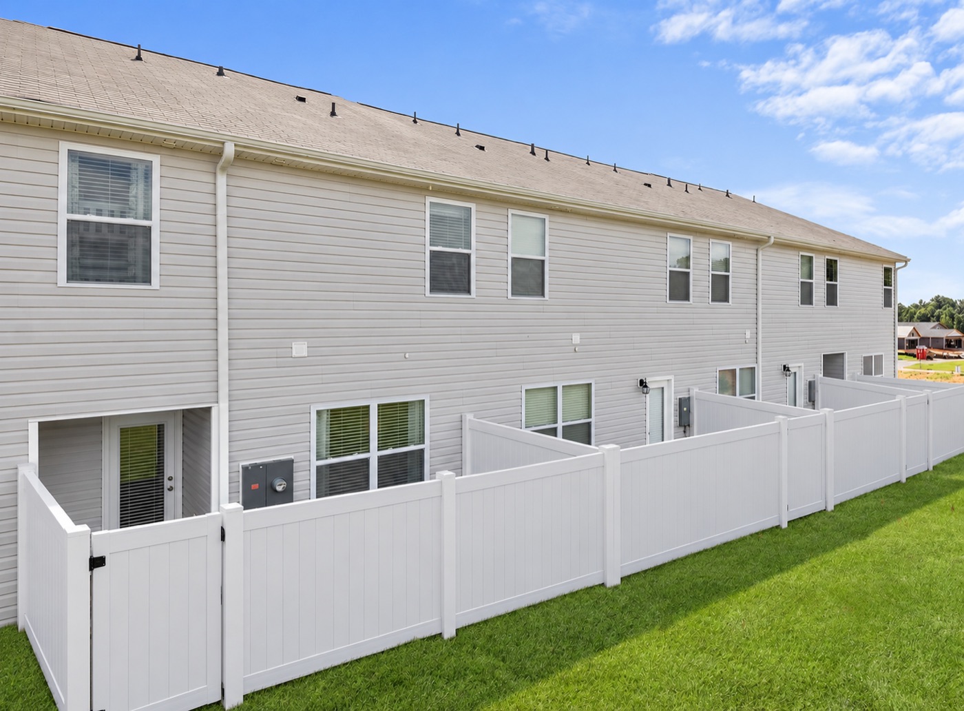 Row of Hubbard townhomes with private fenced backyards