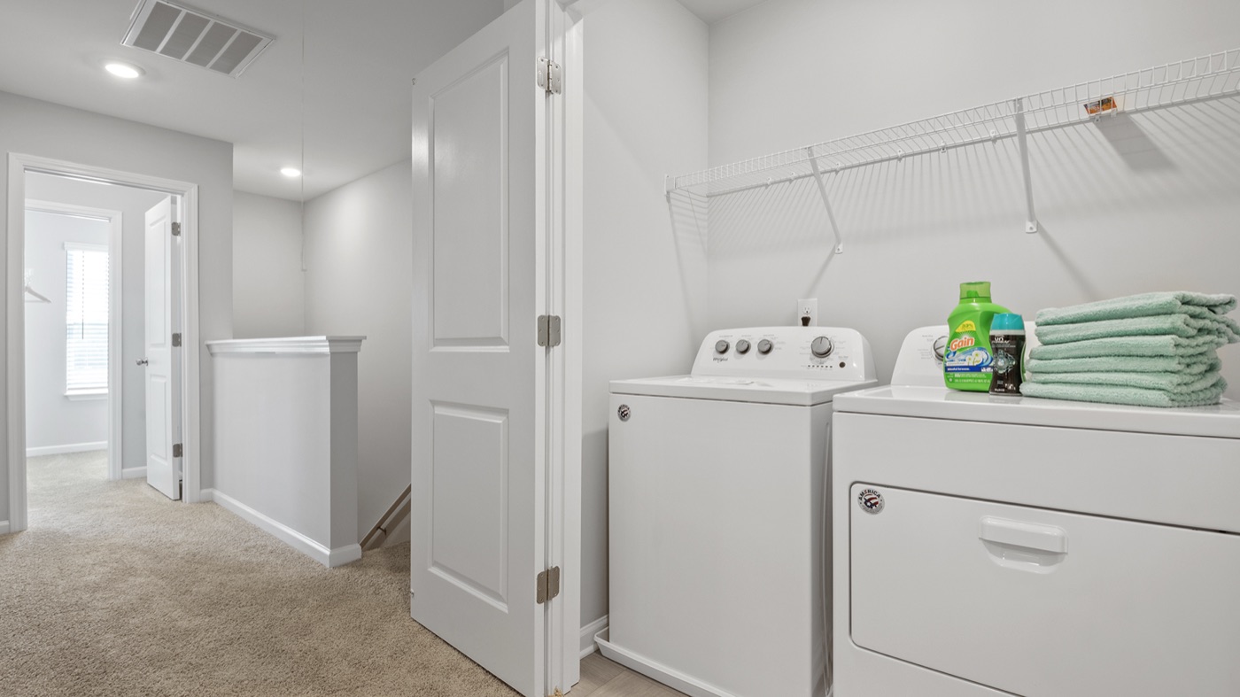 In-home laundry room with a full-size washer and dryer