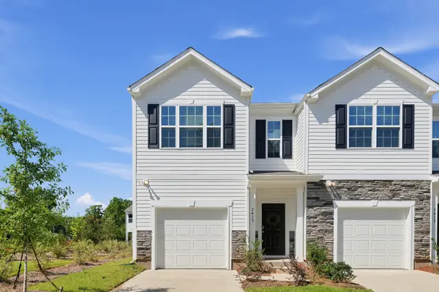 Maywood townhome exterior with covered entry and attached garage