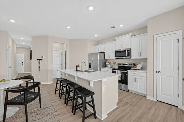 Maywood kitchen with island, pantry door, and stainless steel appliances