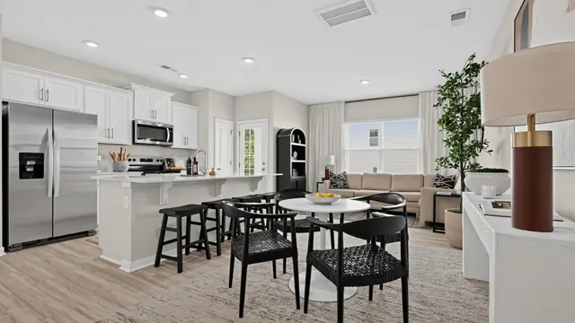 Maywood open main level with kitchen island, dining table, and living room