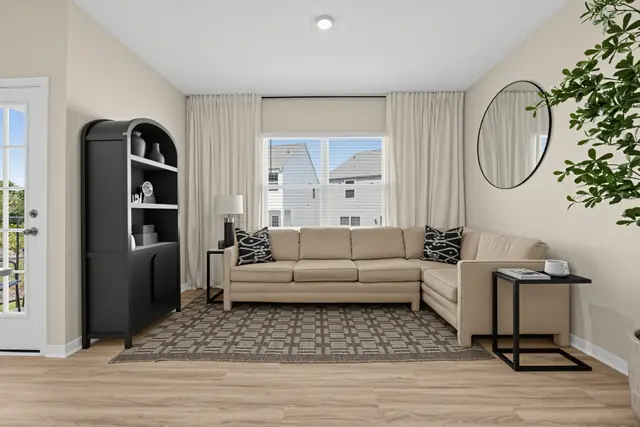 Maywood living room with sectional sofa and door to the patio