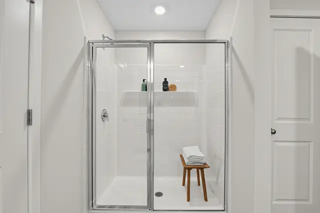 Maywood walk-in shower with glass door and built-in shelf