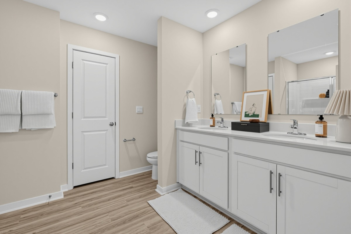 Hubbard primary bathroom with a double vanity and white cabinets